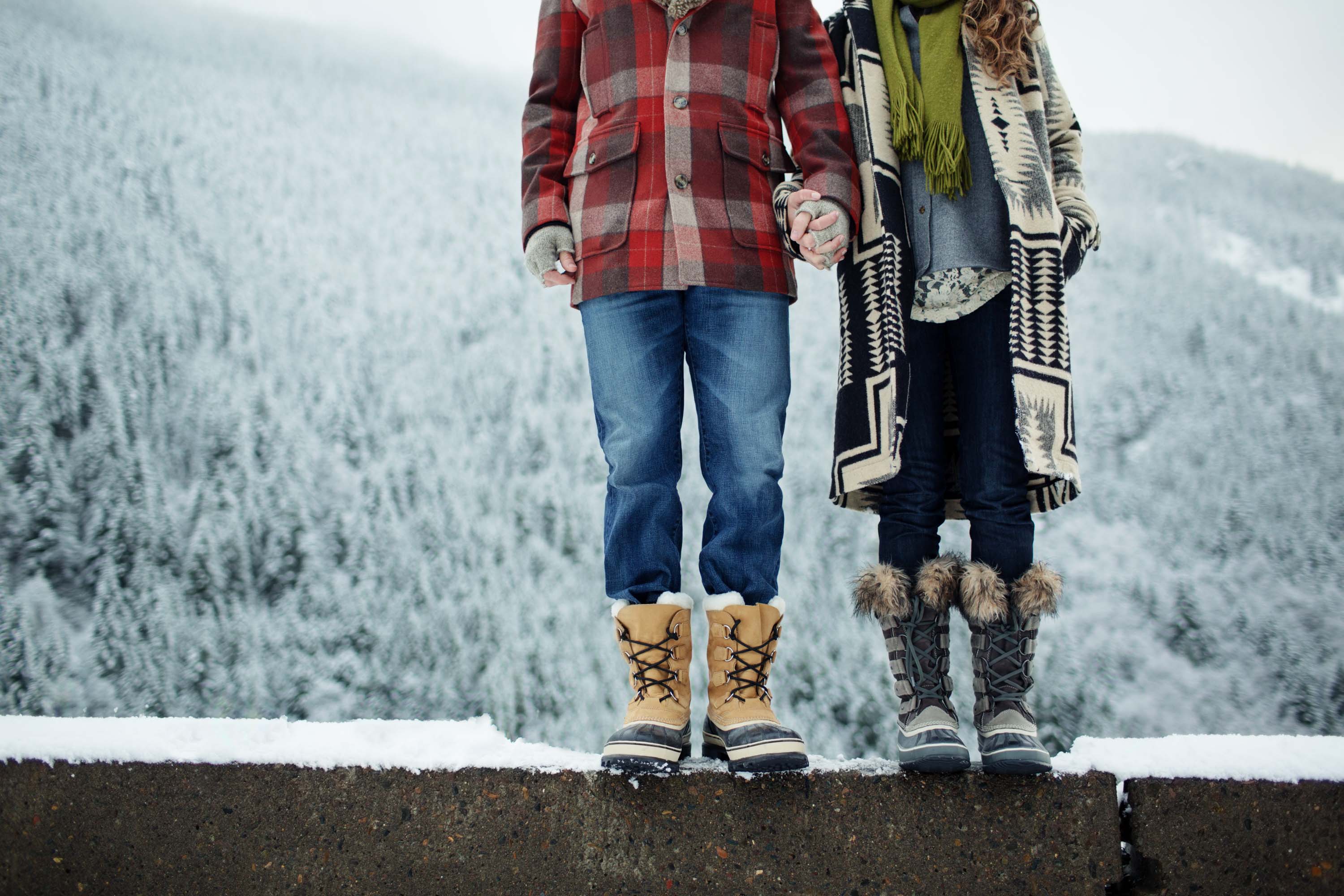 Couple holds hands in the snow